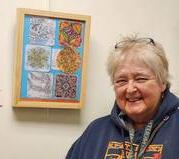 Suzi Rump, artist with her artwork at Aging Resource Center Art Show